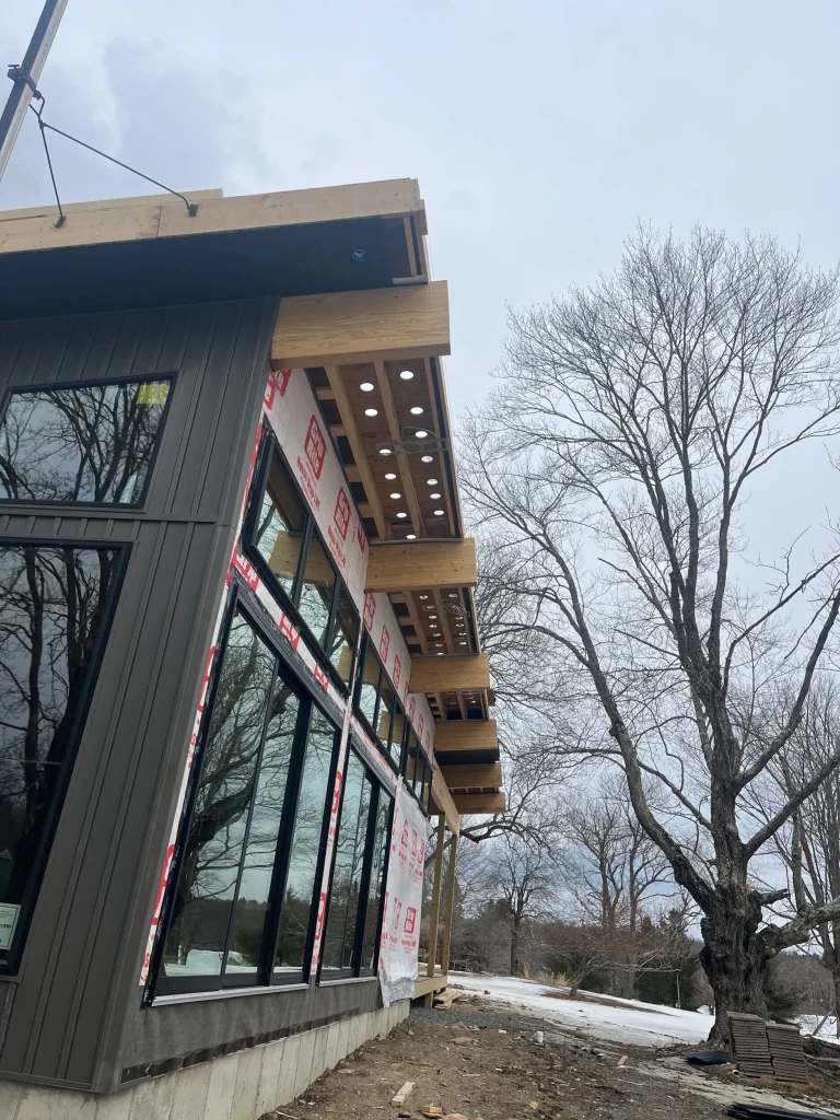 Exterior; rafters, windows, and metal siding. Roof Installation in progress.