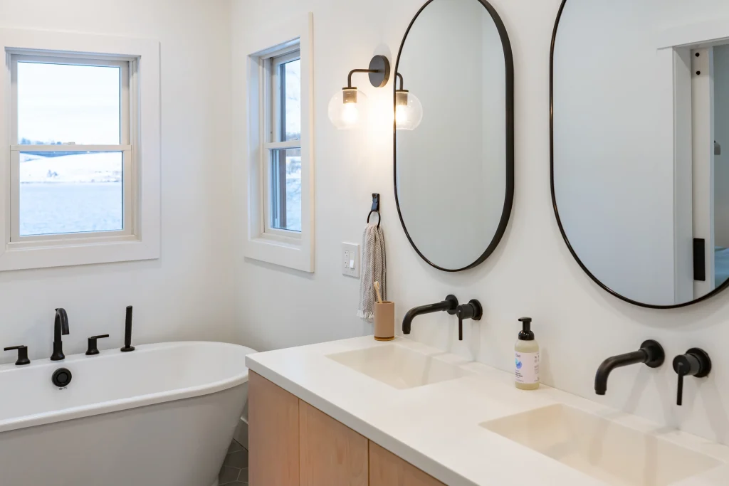 his and hers sink with bathtub and mirrors